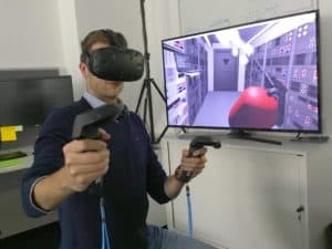 Man playing in virtual Reality game room