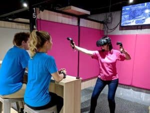 Woman playing in virtual Reality game room