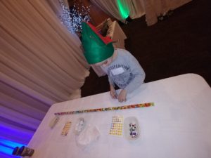 Child with candy line on table