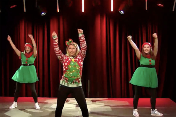 3 holiday dancers with arms in air on Zoom video