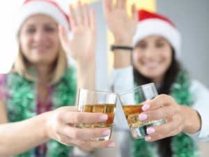 Women with drinks and xmas hats