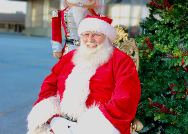 Jolly Santa smiling on throne in parking lot