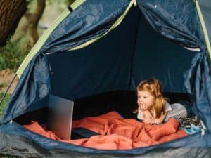 Girl in tent with laptop
