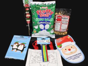 A group of gifts: Candy, caramel popcorn, rnament kit, stickers, bag and pens